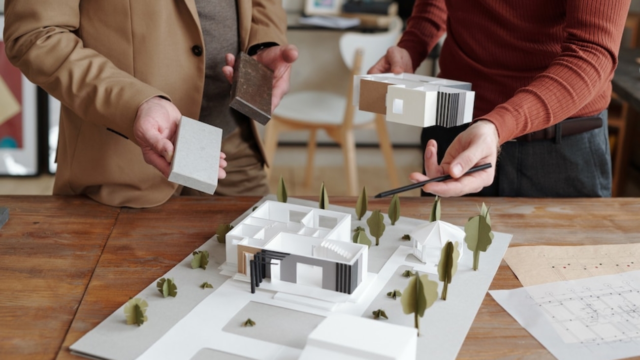 [fpdl.in]_hands-young-male-architect-pointing-model-new-house-that-his-mature-colleague-choosing-suitable-block-construction_274679-18747_large