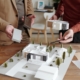 [fpdl.in]_hands-young-male-architect-pointing-model-new-house-that-his-mature-colleague-choosing-suitable-block-construction_274679-18747_large